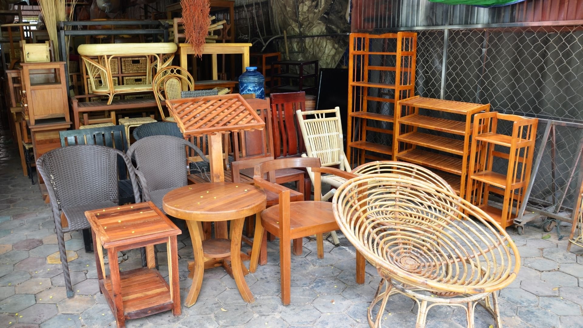 Furniture shop display with wooden chairs, tables, shelves, and wicker pieces